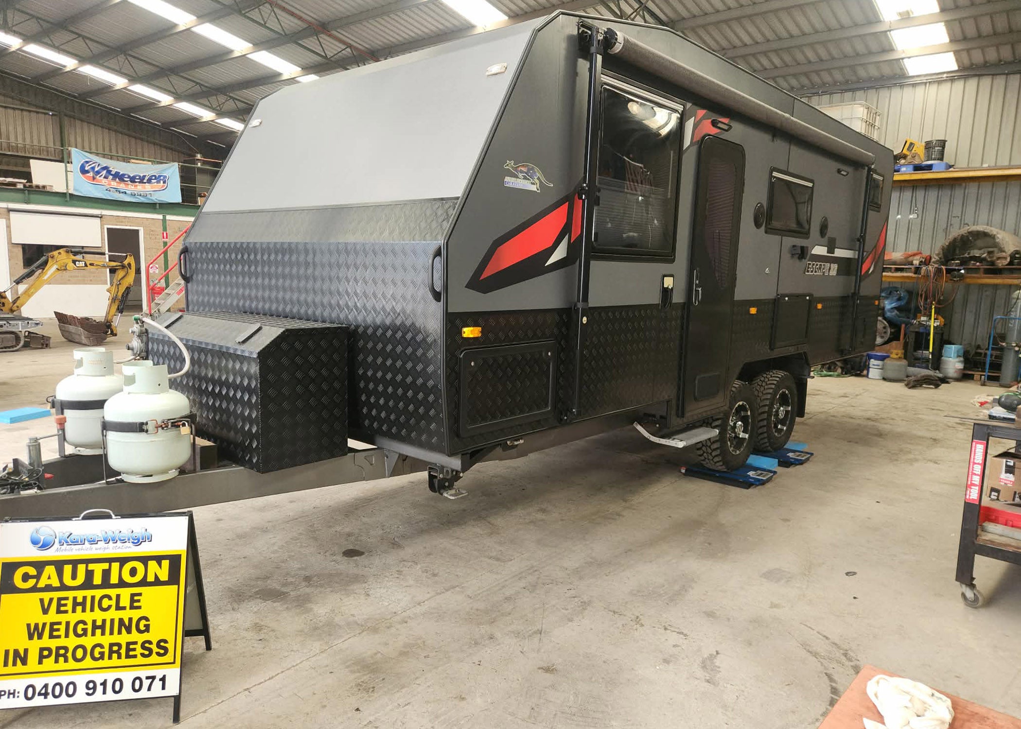 Kara-Weigh mobile caravan and trailer weighing service using blue pads to check ATM and GTM compliance in NSW.